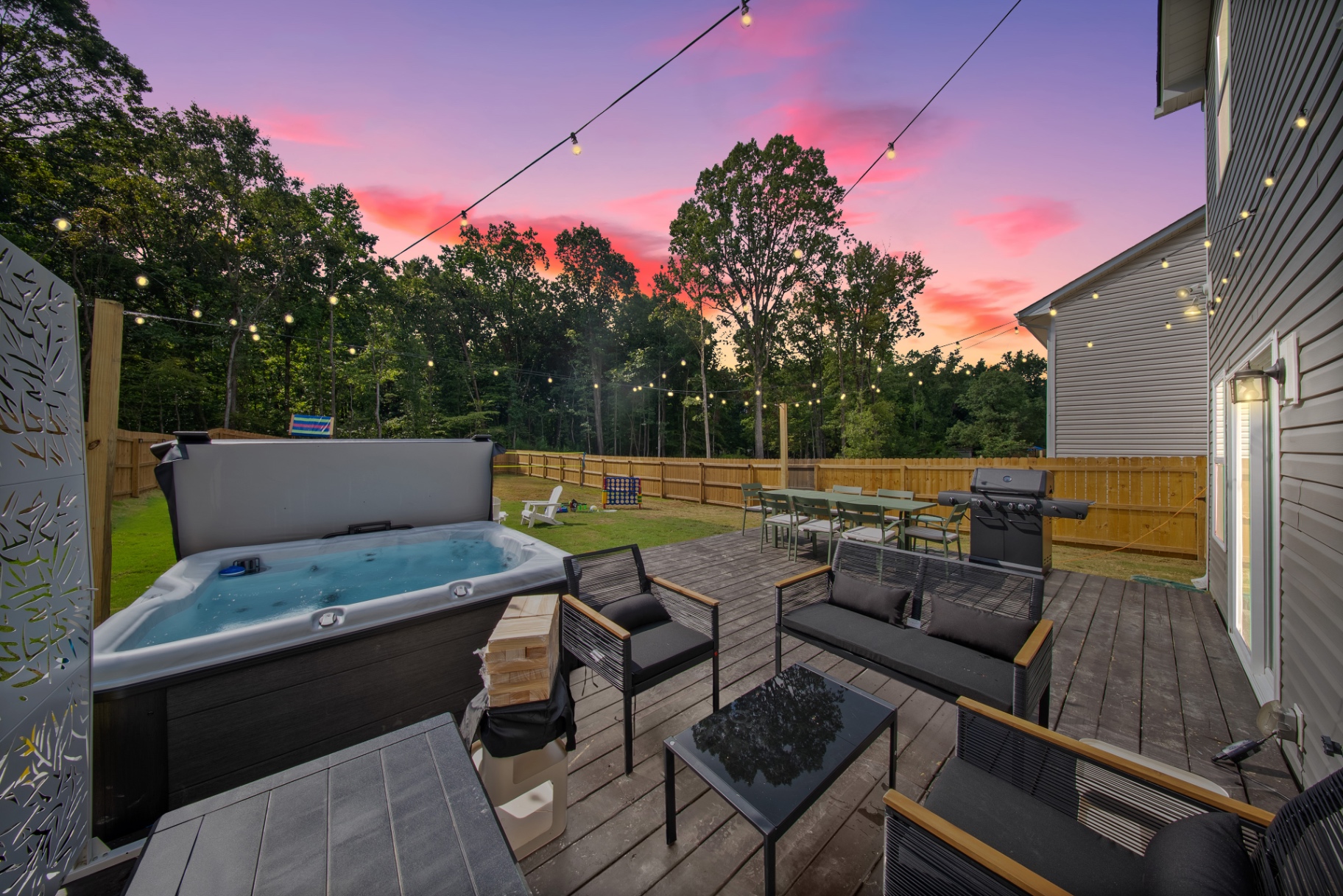 Boutique Charlotte rental patio with hot tub at sunset